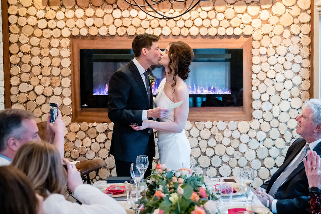 a couple kissing at their small, intimate wedding ceremony
