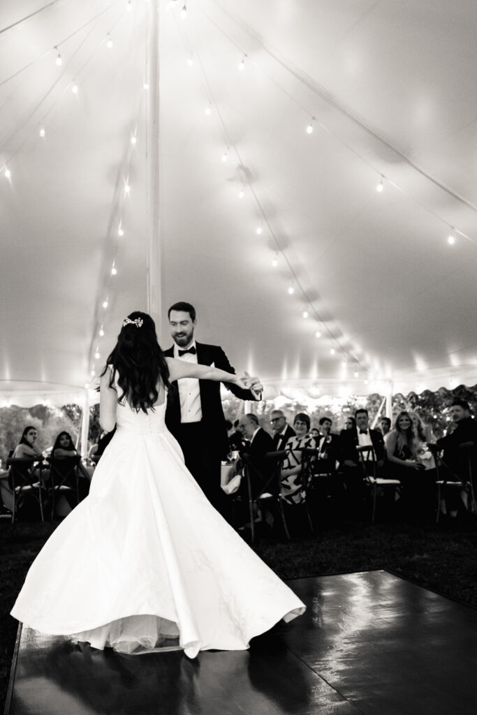 A newlywed couple during their first dance at their reception 