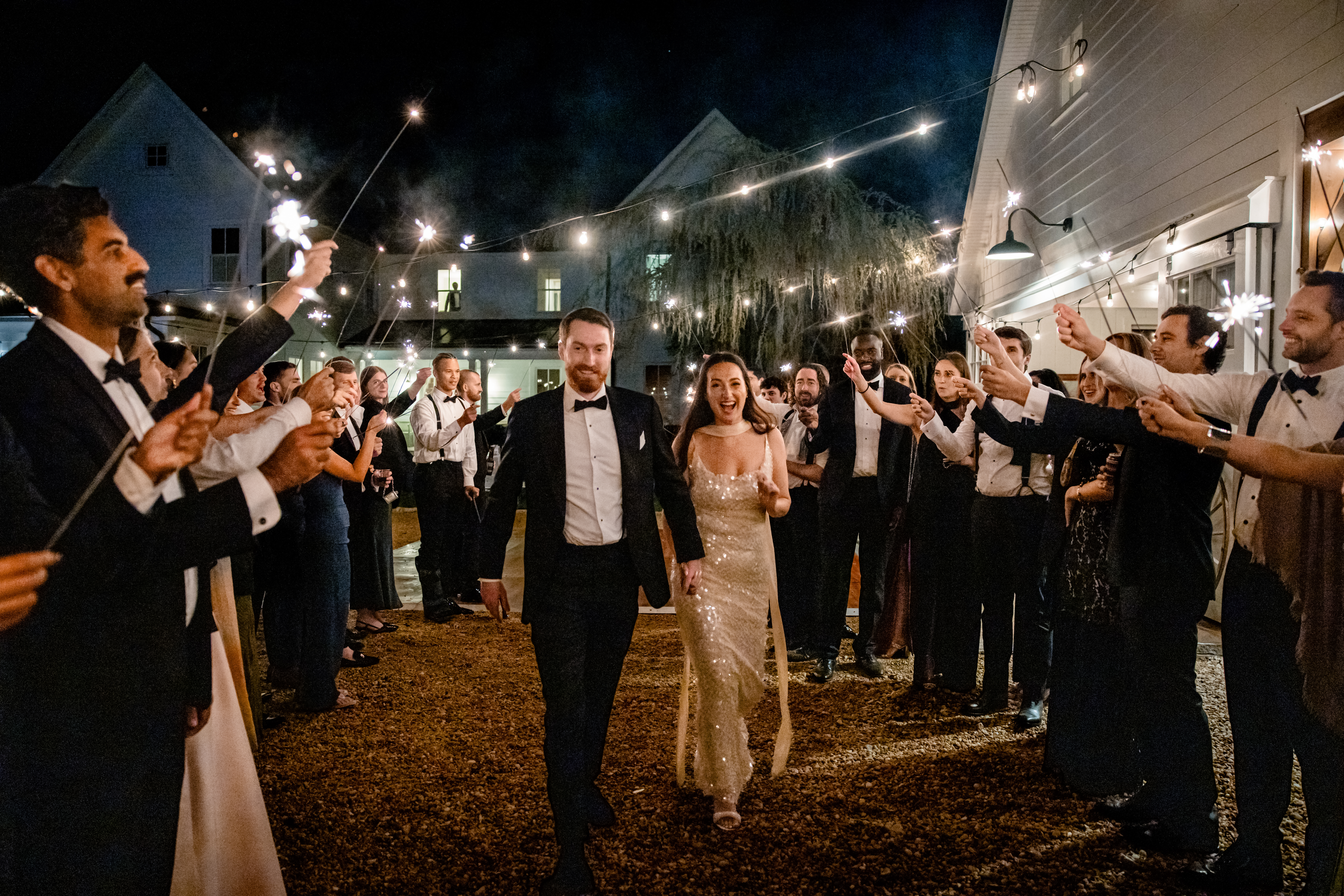 a couple walking hand in hand to a sparkler exit 
