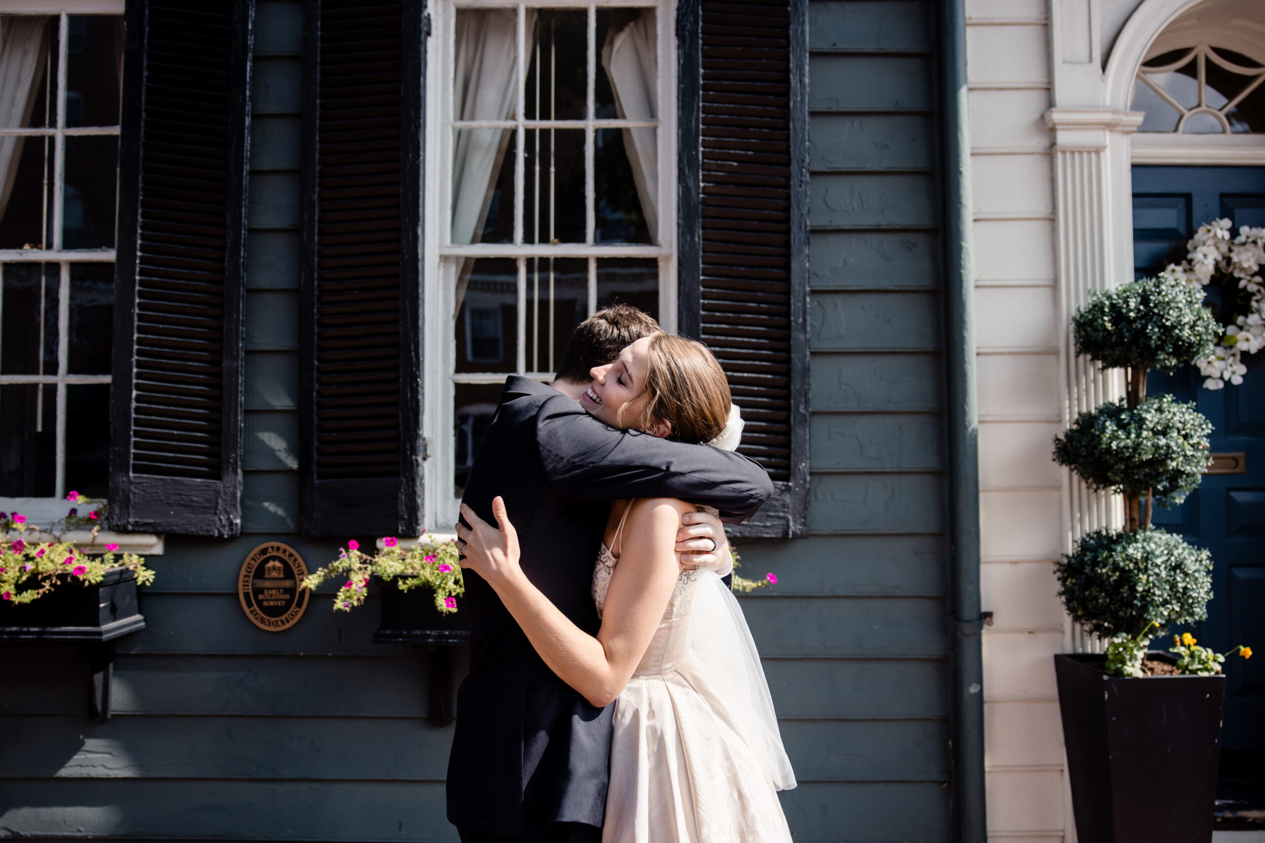 a man and woman embracing each other as they share a first look on the day of their wedding
