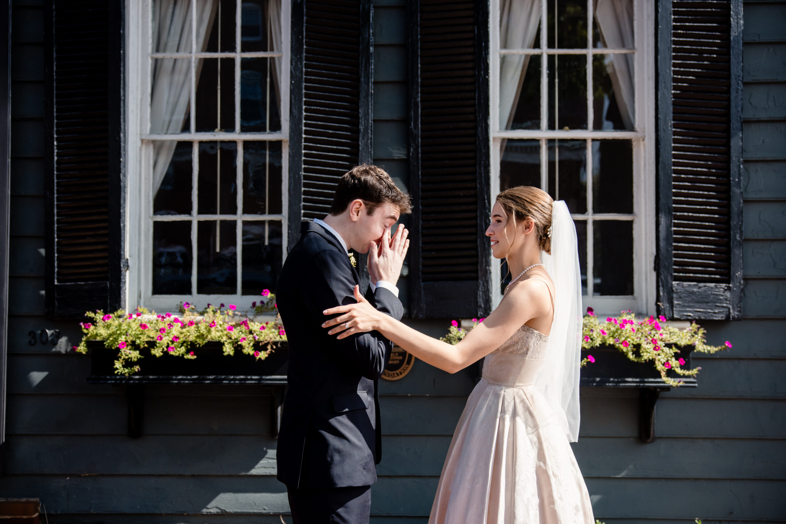 a man getting emotional after sharing a first look with his bride