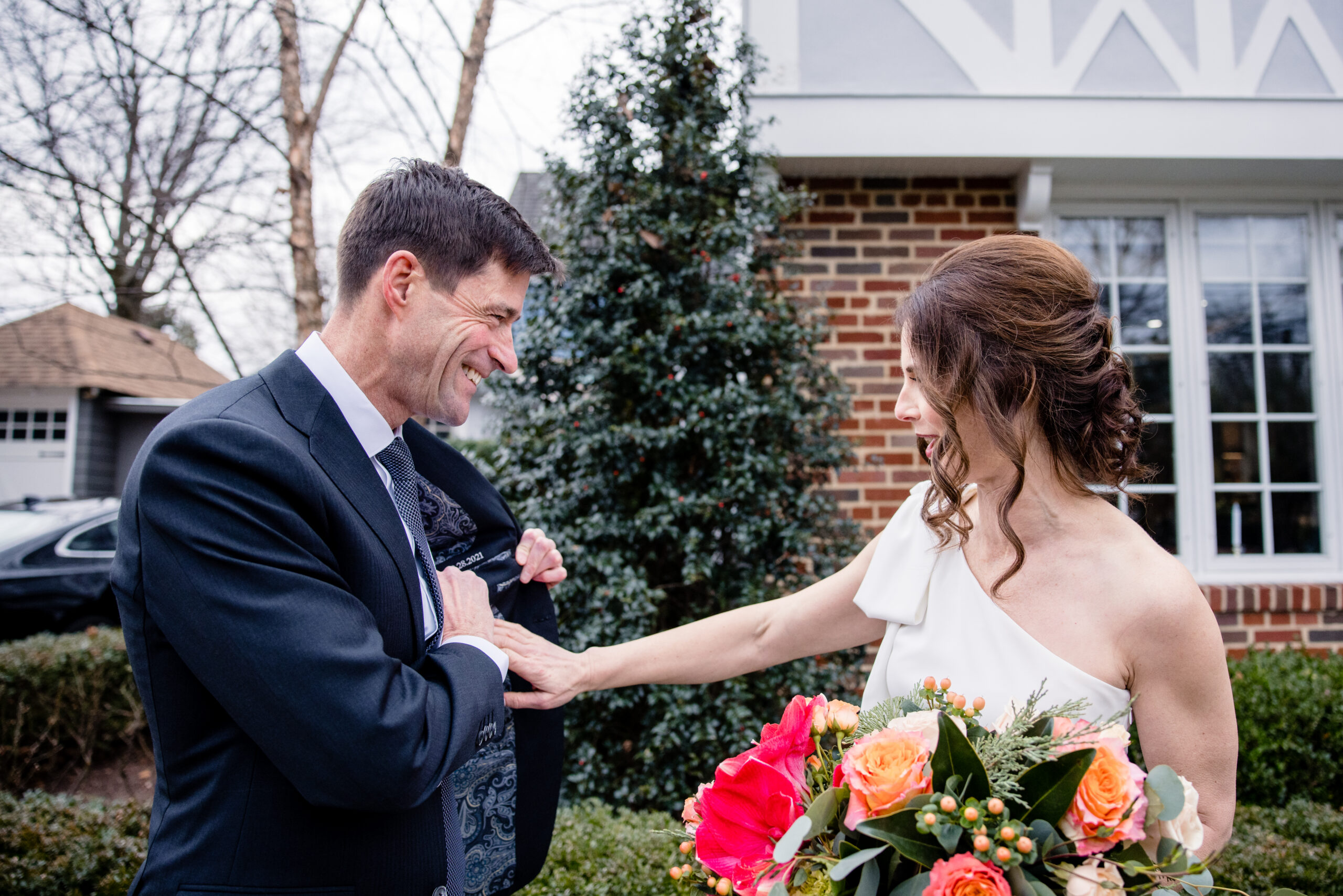 a couple smiling at each other as they share a first look