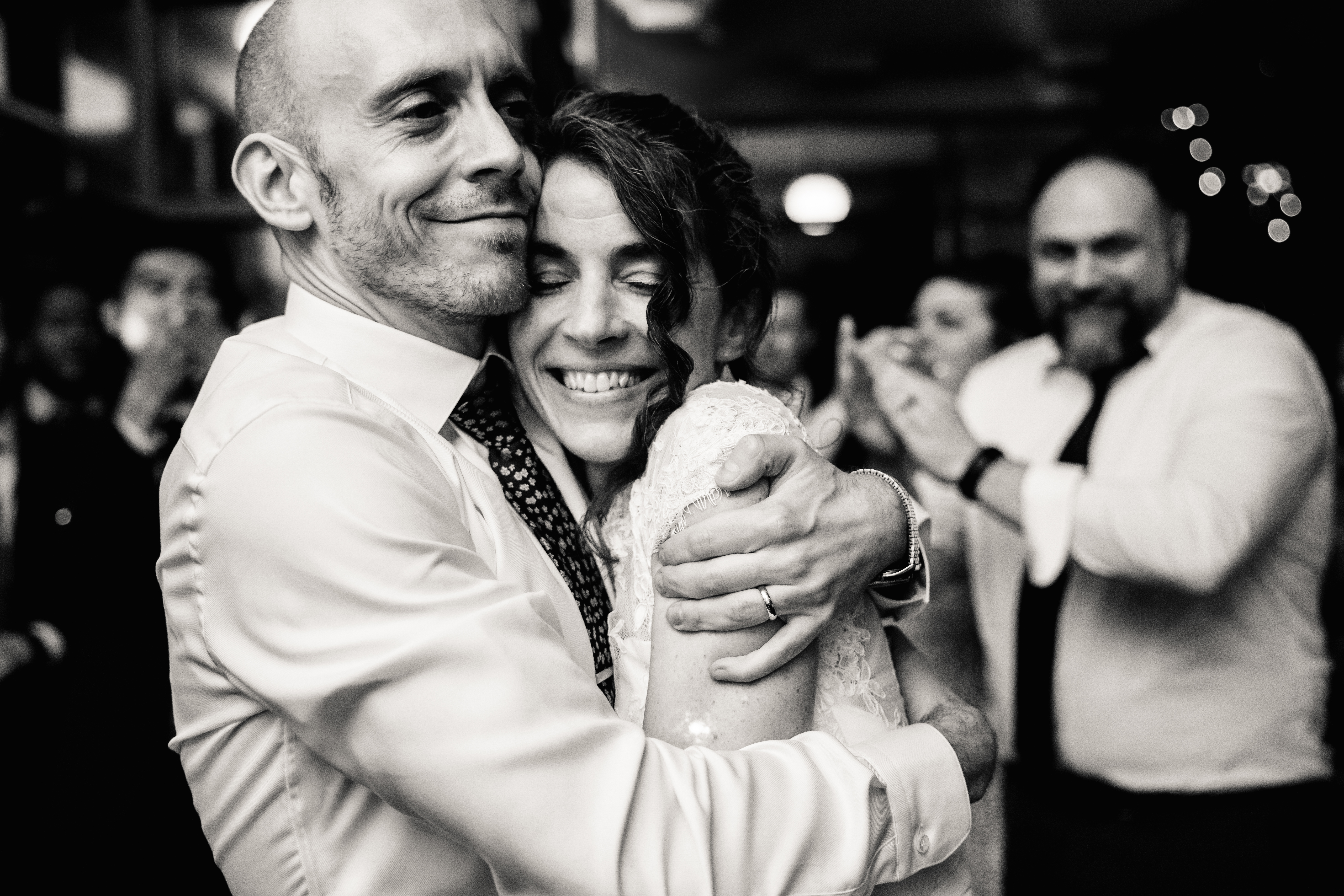 a man and woman hugging at their wedding reception 