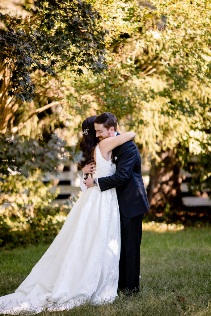 a bride and groom embracing after exchanging private vows outdoors