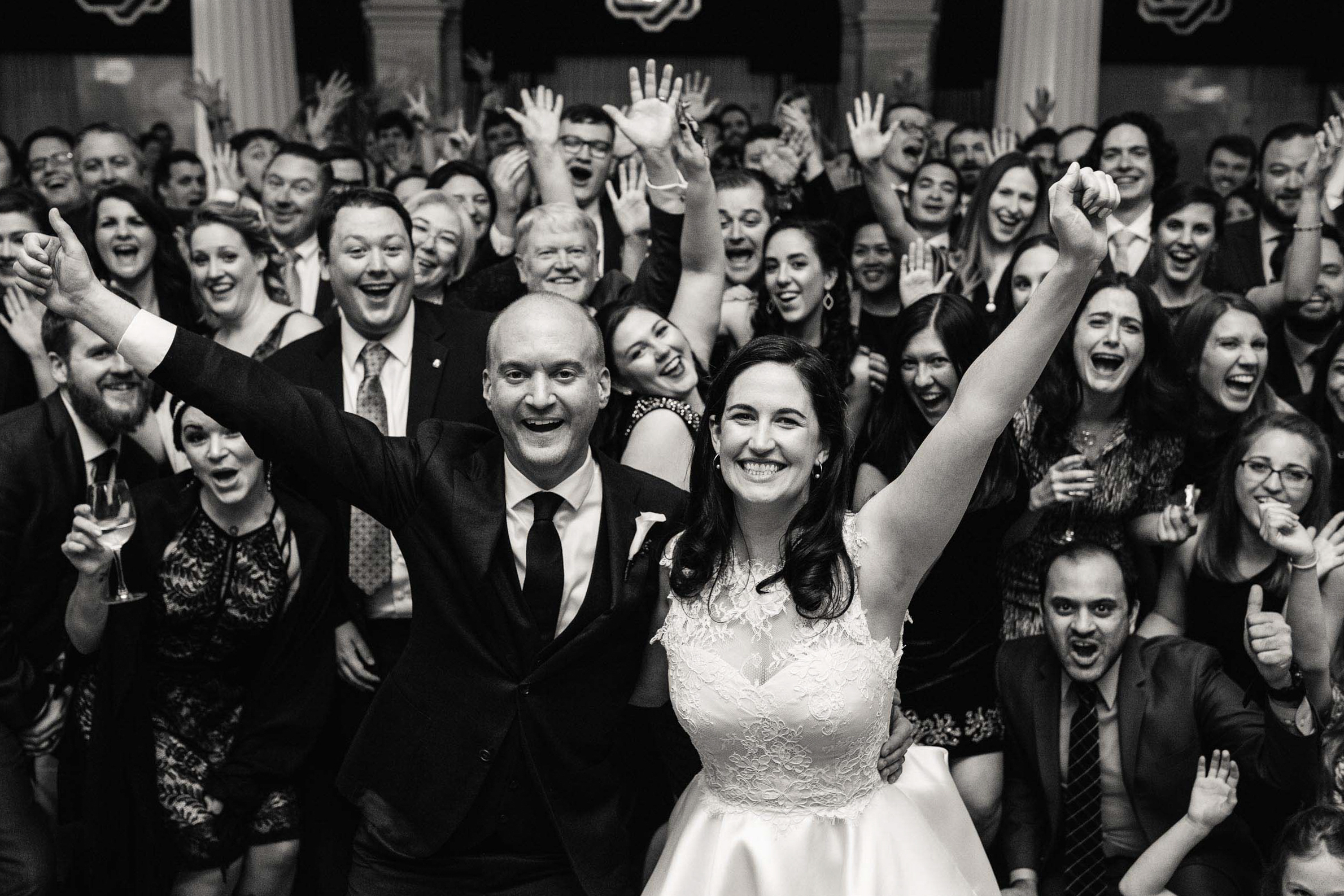 a bride and groom taking a family photo at their wedding reception