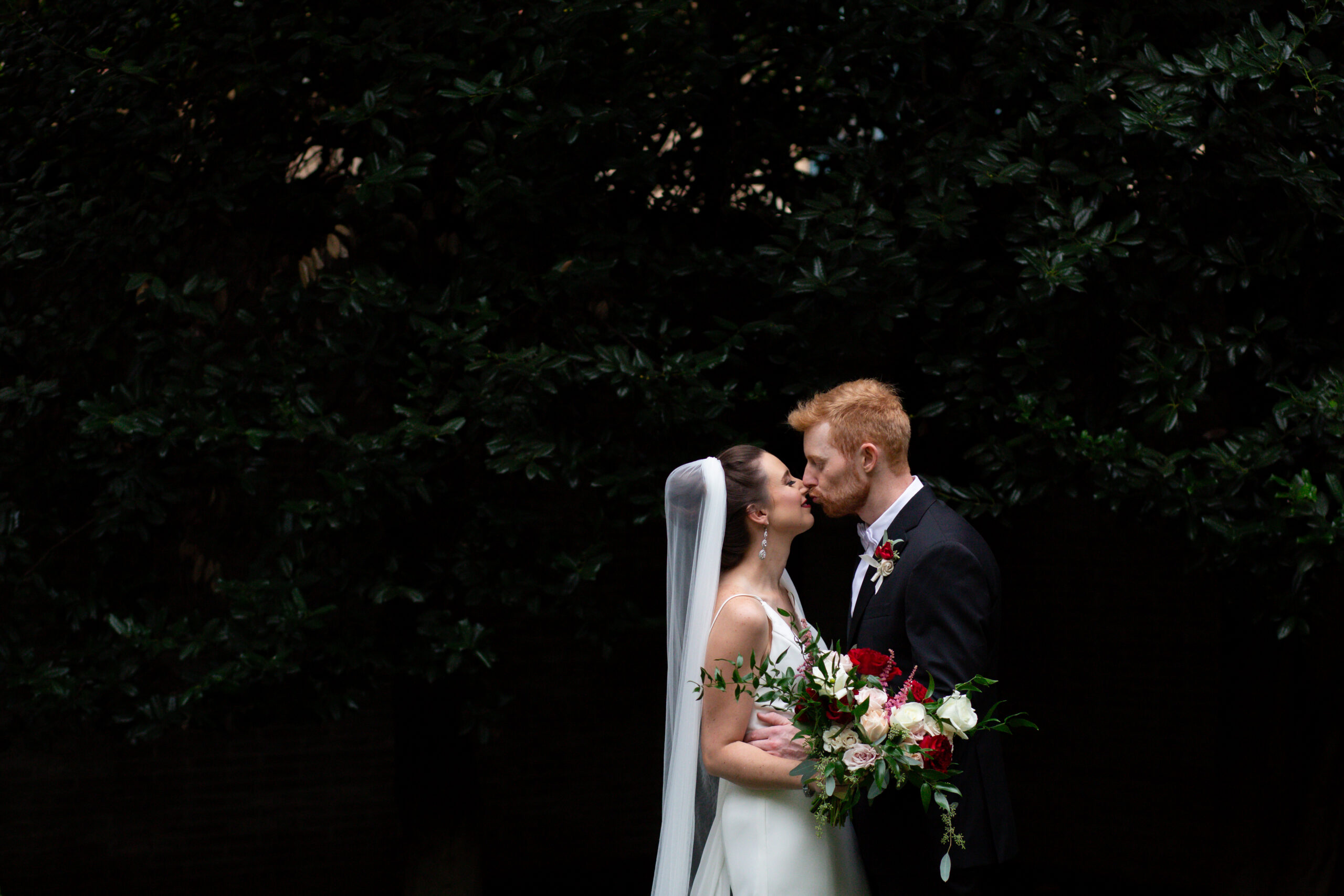 a bride and groom kissing at twilight 