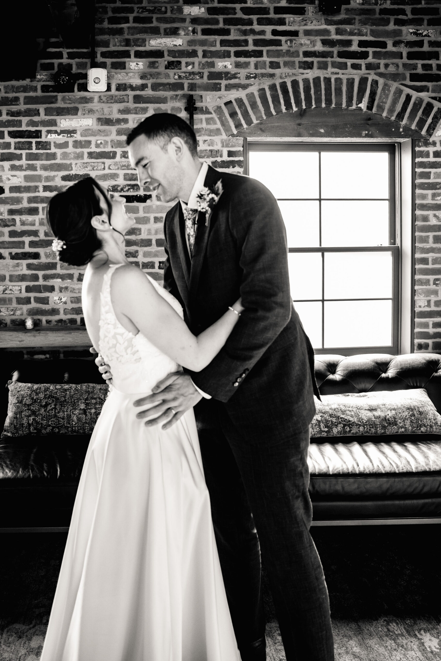 a bride and groom embracing each other and smiling on the day of their wedding 