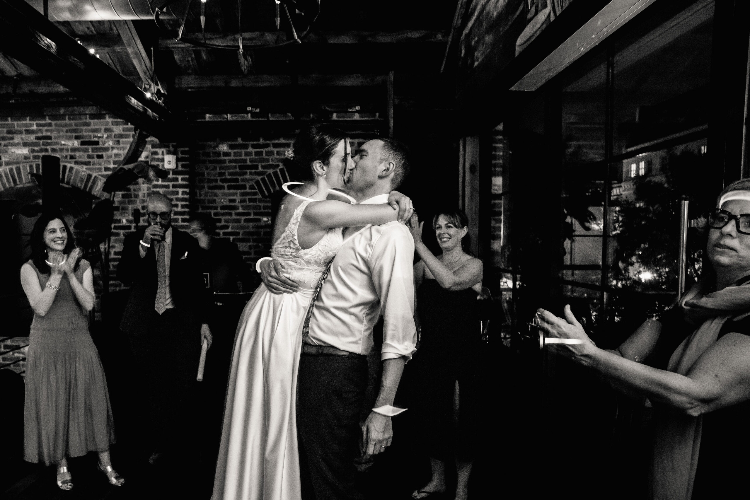 a bride and groom kissing each other at their wedding reception 
