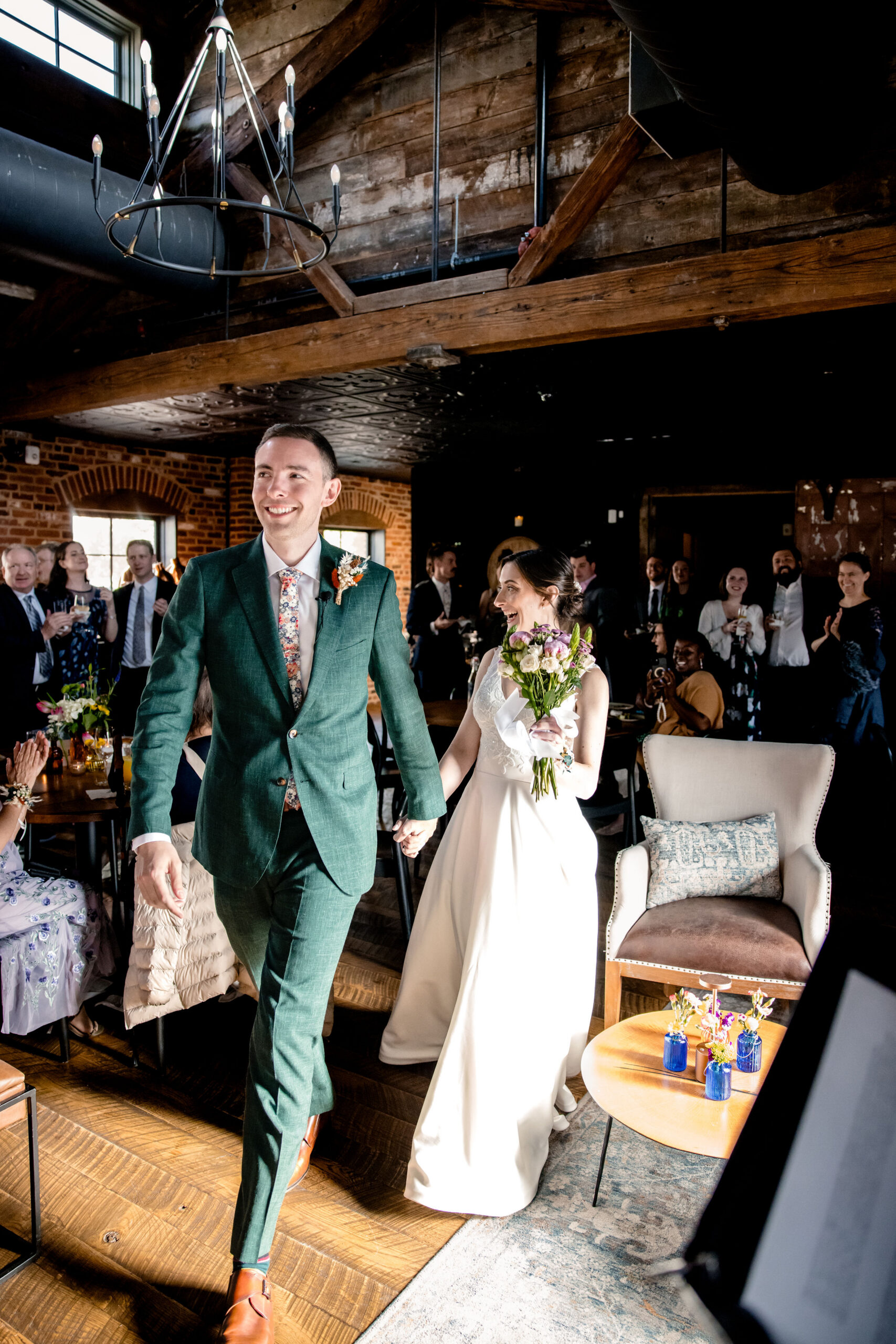a couple walking into their wedding ceremony together holding hands at cooper mill in virginia