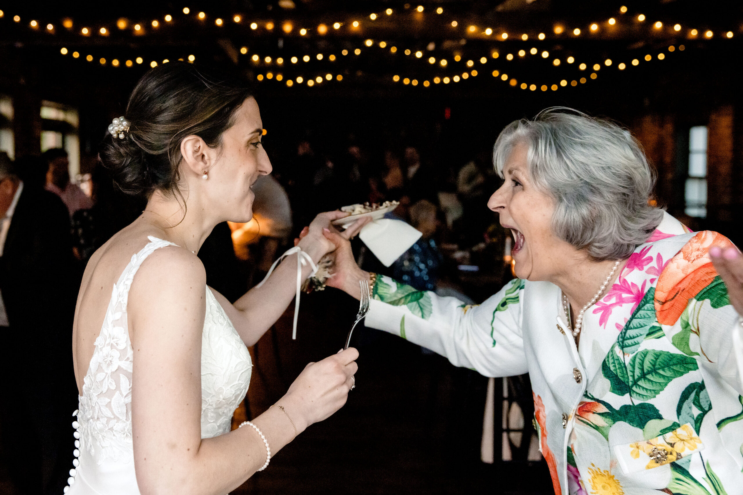 a woman laughing with her mom on the day of her wedding